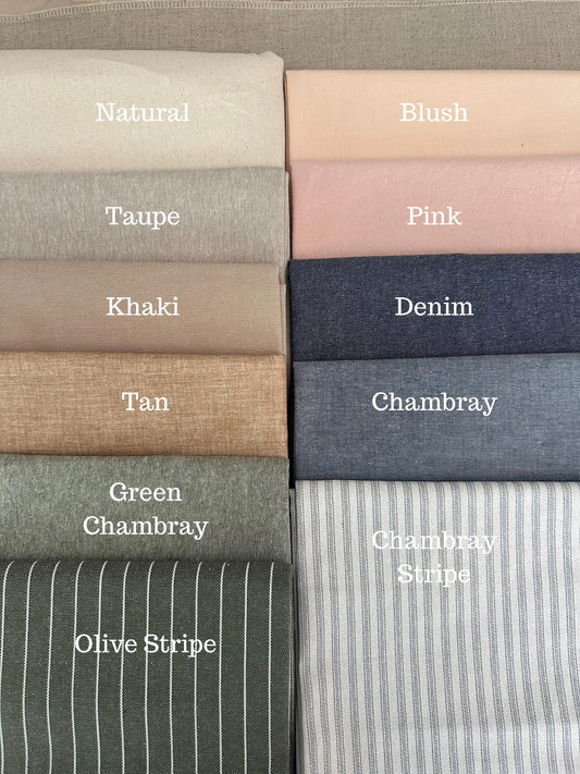 Collection of folded fabric swatches in various colors with labels.