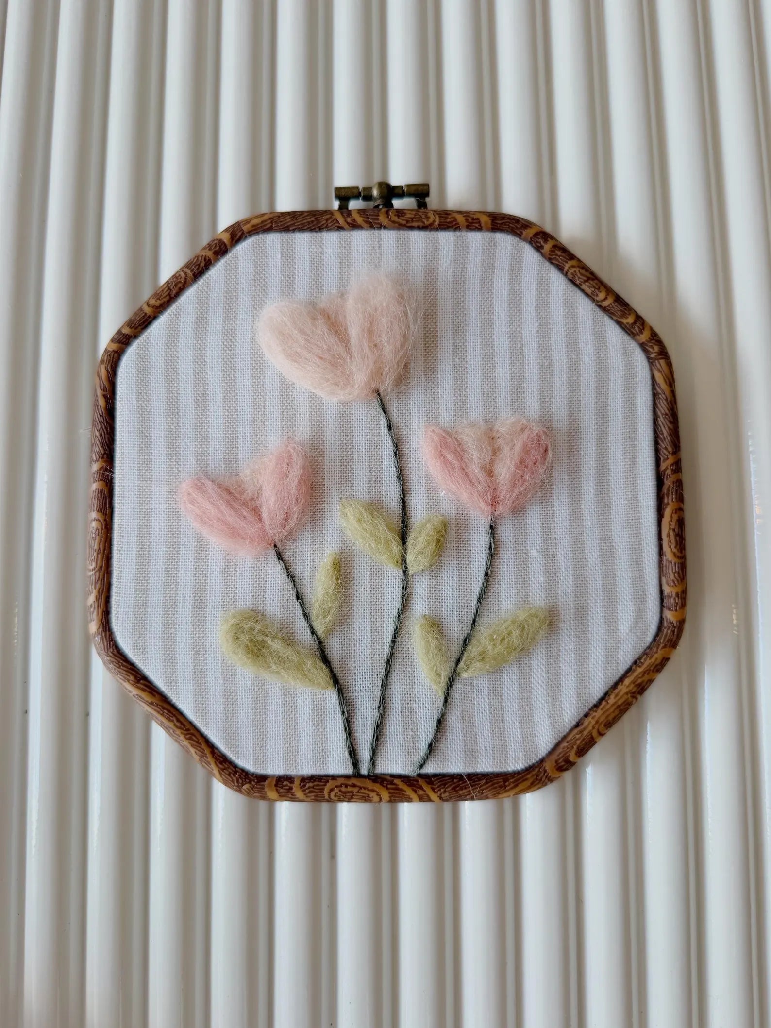 Blush felted flowers on a wooden hoop