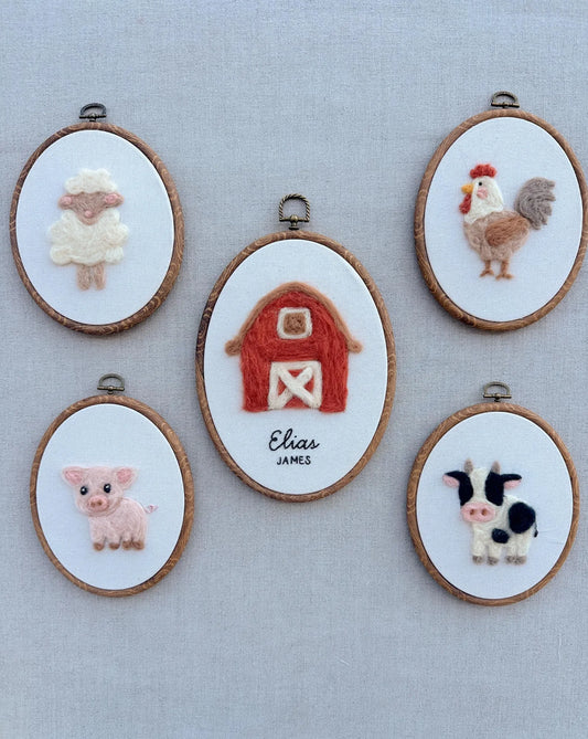 Set of embroidered hoop art with farm animals on a light gray background